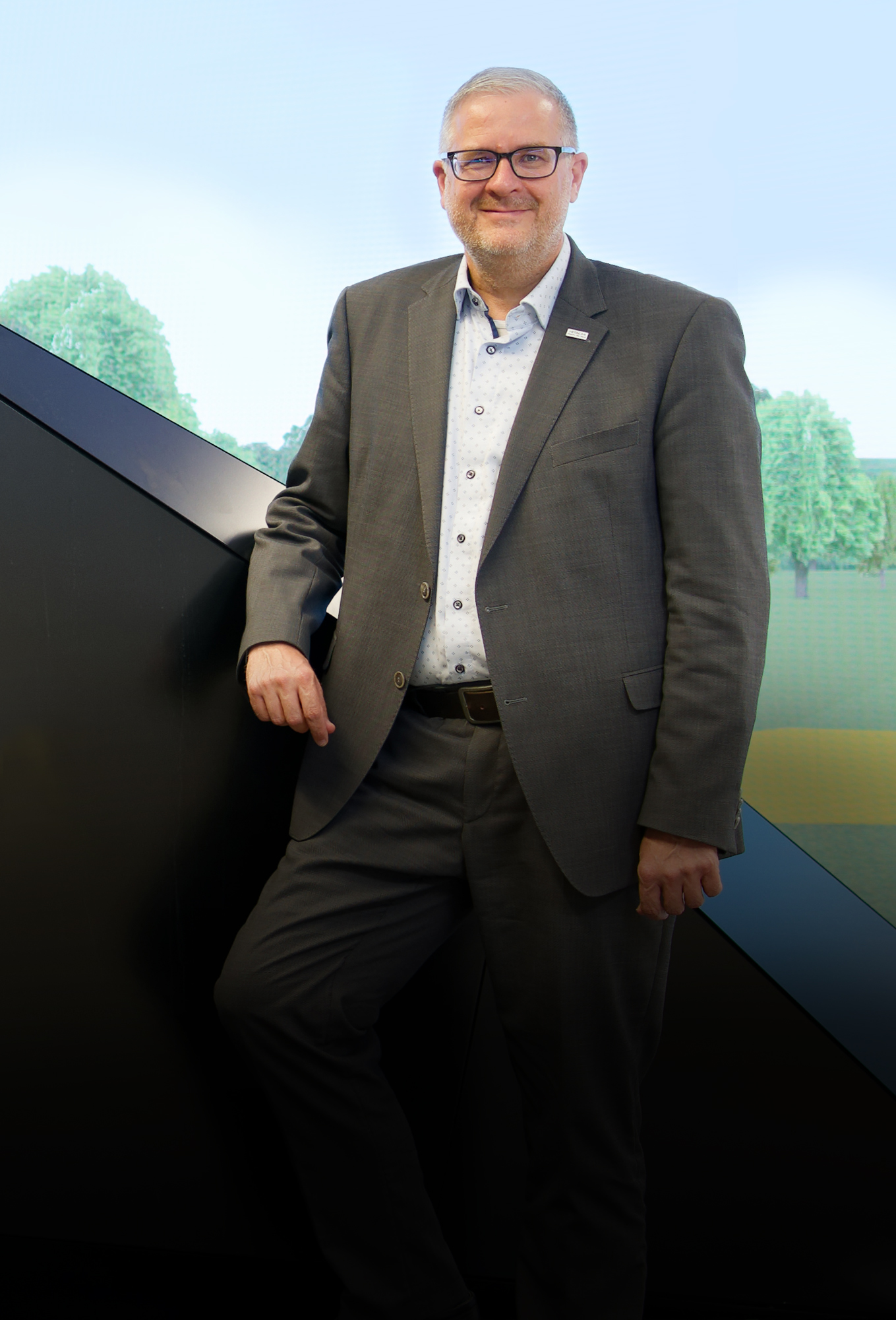 Vor dem „Railbot“ im Showroom von Hitachi Rail am Standort Ditzingen, nahe Stuttgart: In seiner Rolle als Vice President Markets Germany & Global Account Manager Deutsche Bahn, treibt Markus Fritz die Modernisierung des Schienenverkehrs in Deutschland voran.
